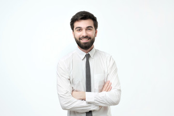 smiling man with crossed arms over gray background