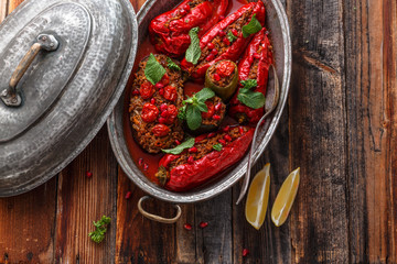 Rice stuffed vegetables in tomato sauce, top view, copy space