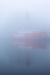 ship at the pier on the river in a thick dense fog