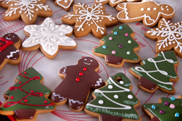 Christmas cookies funny gingerbread man, snowflakes, tree on the baking tray.