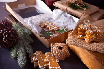 Christmas cookies snowflakes, gingerbread man, tree and gifts box on the wooden table
