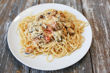 Homemade italian pasta with musselss, seafoods and parmezan. Tasty vegeterian food.