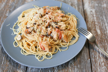 Homemade italian pasta with musselss, seafoods and parmezan. Tasty vegeterian food.