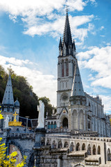 Fototapeta premium view of the basilica of Lourdes in autumn, France