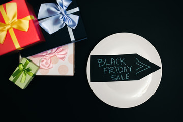Black Friday concept photo with an arrow. Present boxes for Birthday parties. Sale and discount. Shopping ideas. Special offer.