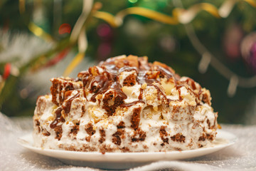 New Year's cake on background of Christmas tree