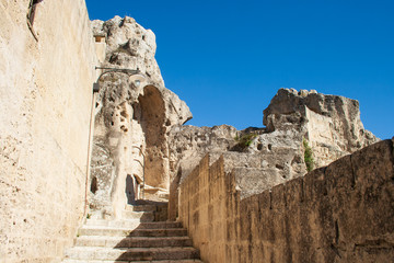 Fototapeta premium Old stairs among rocks of Sassi or stones of Matera European capital of culture 2019, Basilicata, Italy, vertical