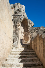 Fototapeta premium Old stairs among rocks of Sassi or stones of Matera European capital of culture 2019, Basilicata, Italy, vertical