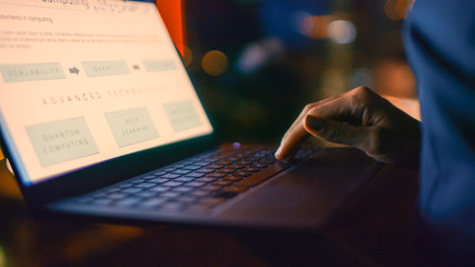 Close-up on Hands of the Businesswoman Holding Laptop, Standing Near the Window of Her Office. Late...