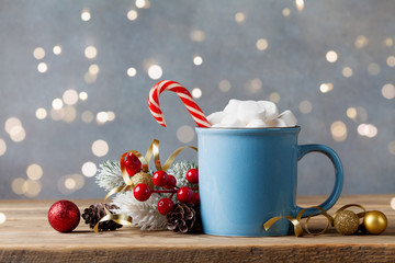 Winter lifestyle with cup of hot cocoa with marshmallows and Christmas decoration on wooden...