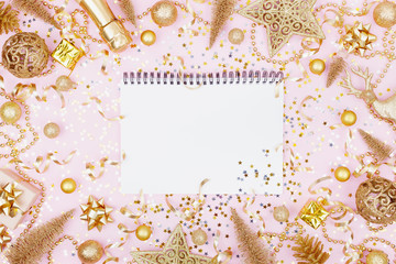 Christmas background of empty notebook and golden holiday decorations top view. Flat lay.