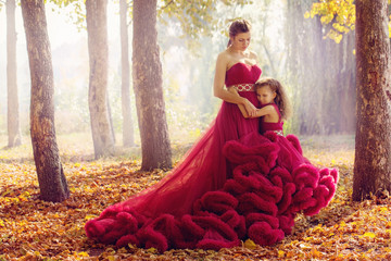 Fototapeta premium Mom and daughter in luxurious dresses