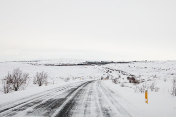 Fototapeta premium Beautiful and dangerous driving road in winter snow Iceland