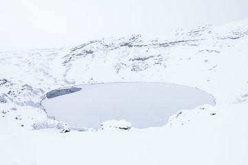 Fototapeta na wymiar Kerid volcano crater during winter snow in Iceland
