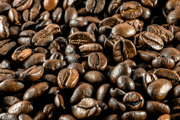 Background:a lot of coffee whole grains lies. Horizontal toned photography