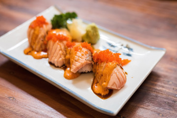 Salmon Sushi roll with fire burn