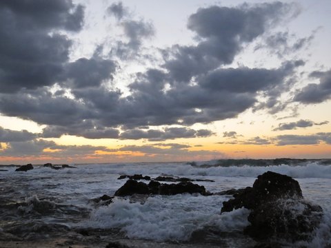 Beautiful Colorful Sunset Dawn Over Sea Waves Hitting Rocky Stone Beach