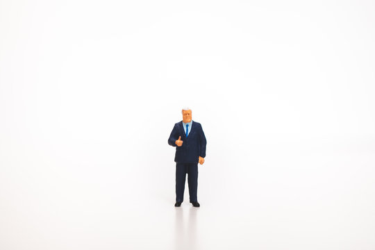 Miniature people, businessman action isolated on white background using as business concept