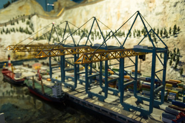 Miniature model of cranes at shipping dock