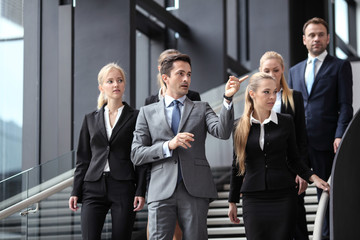 Group of business people walking at stairs