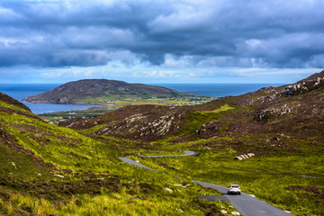 Car driving on a lonley road through Gap of Mamore, Inishowen, County Donegal, Ireland