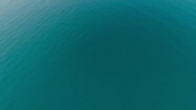 Top view calm turquoise sea surface amazing ocean water with small waves and ripples texture aerial shot tranquility seaside top-down view