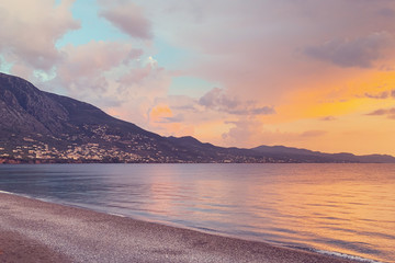 Beautiful view on a landscape: seashore, mountains and sunset