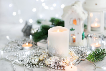 Fototapeta na wymiar White candle on holiday silver background, Christmas concept