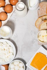 assortment of fresh farm dairy products on white background, vertical top view