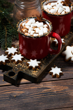 cozy winter drink hot chocolate on a wooden table, vertical top view