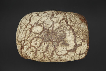 Grey bread loaf isolated on black background