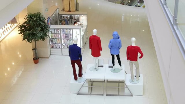 An empty teenage fashion store with four mannequin displaying the latest trend with jeans, hoodies and t-shirts. Fashion store interior and mannequins. Boutique display window with mannequins.