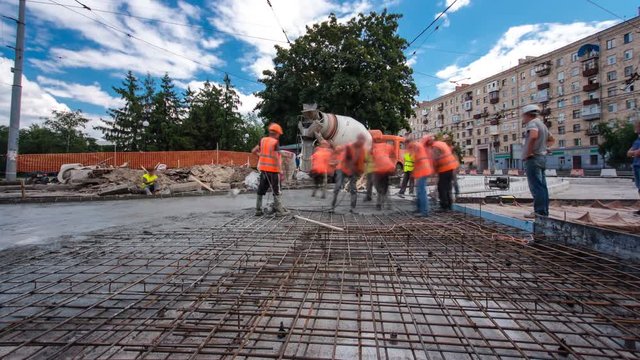 Concrete works for road construction with many workers and mixer timelapse hyperlapse