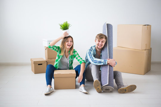 Family, new apartment and relocation concept - Young couple moving in new house