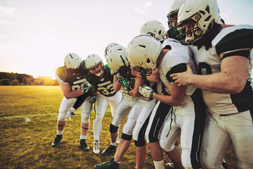 American football team having fun with their captain during prac