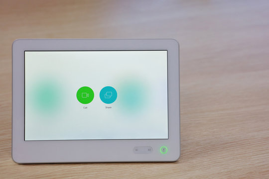 close up screen of tablet with icon to control media in meeting room