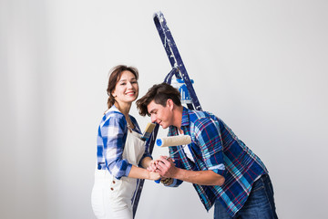 Teamwork, renovation and repair concept - Portrait of funny couple doing redecoration in apartment