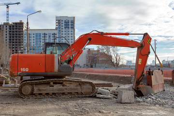 Excavator in the city digging trenches