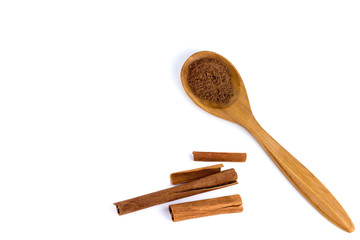 top view of a spoon of sandal wood with cinnamon  isolated on white background