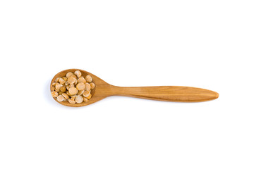 top view of a spoon of sandal wood with dried yellow pea isolated on white background
