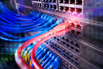 network cables and hub closeup with fiber optical background