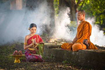  present food to a Buddhist priest