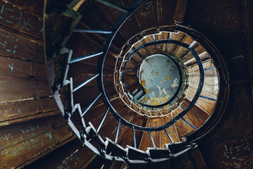The concept of the modern loft. Spiral staircase in an abandoned building. Ideas for designer