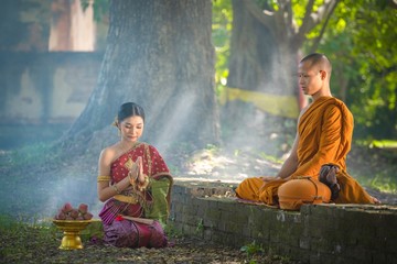  present food to a Buddhist priest