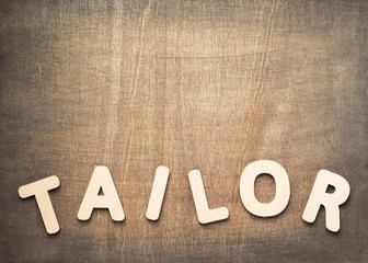 Fototapeta premium tailor letters on wooden table
