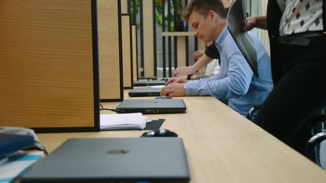 Many hands are typing on a laptop