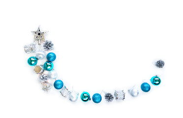 Christmas tree decorative ornaments of silver star, blue balls, pine cone, tinsels and drums over white background with copy space for winter Merry X'mas text insertion, logo or product decoration
