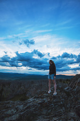 Fototapeta premium Travel, lesure and freedom concept - woman on the top of Altai mountain, beauty summer evening landcape