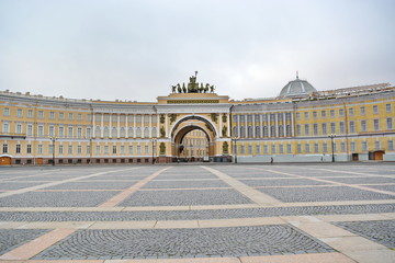 Fototapeta na wymiar Landmark of St. Petersburg, Russia - Deserted Palace square, façade of general staff and triumphal arch with roman chariot in front of Hermitage by early morning without people. Panoramic front view