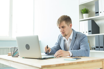 Designer, artist and web design concept - Portrait of young man using digital pen tablet and laptop in the office